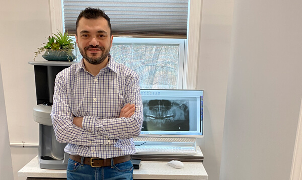 Receptionist talks on phone at Frederick Family Dentistry.